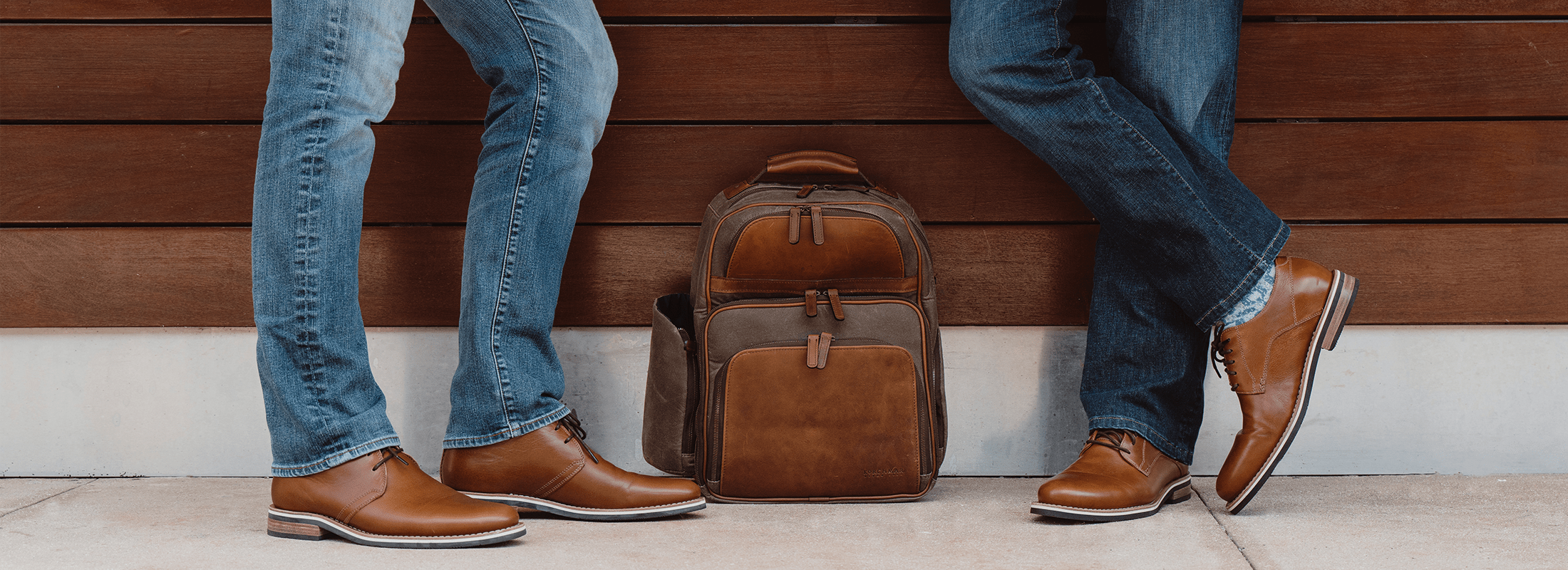 Footwear for Life. Two men wearing HELM with a Korchmar backpack below.